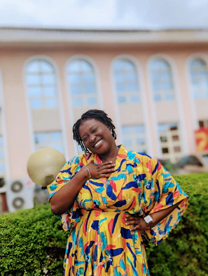 A vibrant outfit featuring bold colors and clean lines, worn by a smiling person at a lively outdoor café.