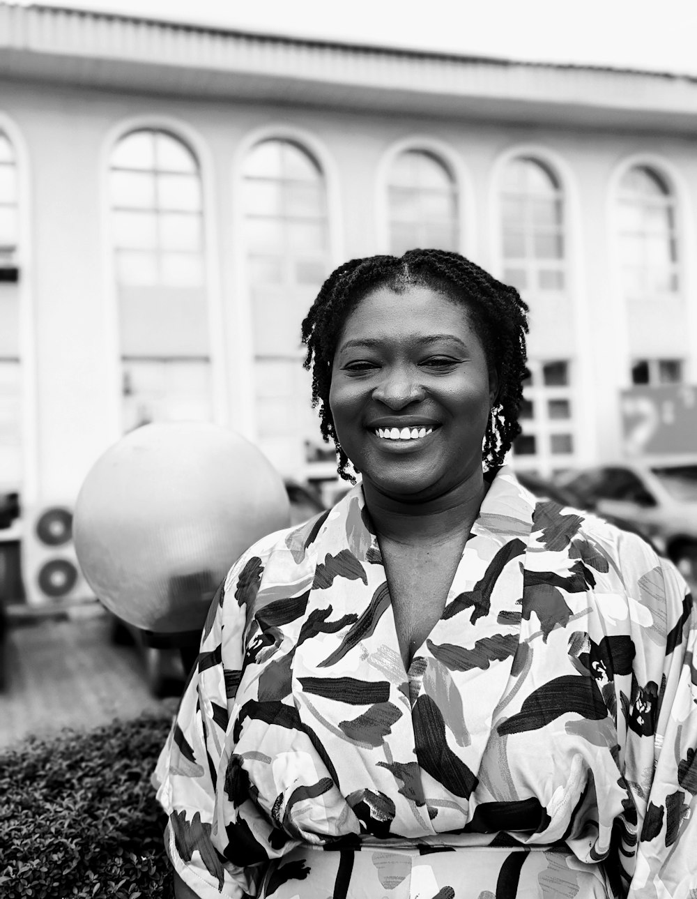 a black and white photo of a woman smiling