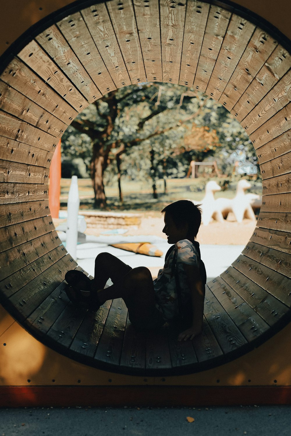 a young boy sitting in front of a circular window