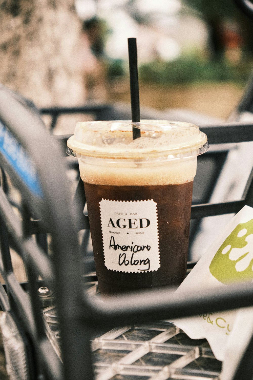 a cup of iced coffee sitting on top of a table