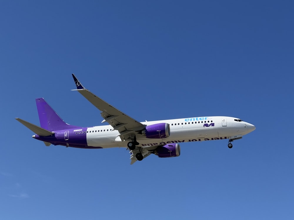 a large passenger jet flying through a blue sky