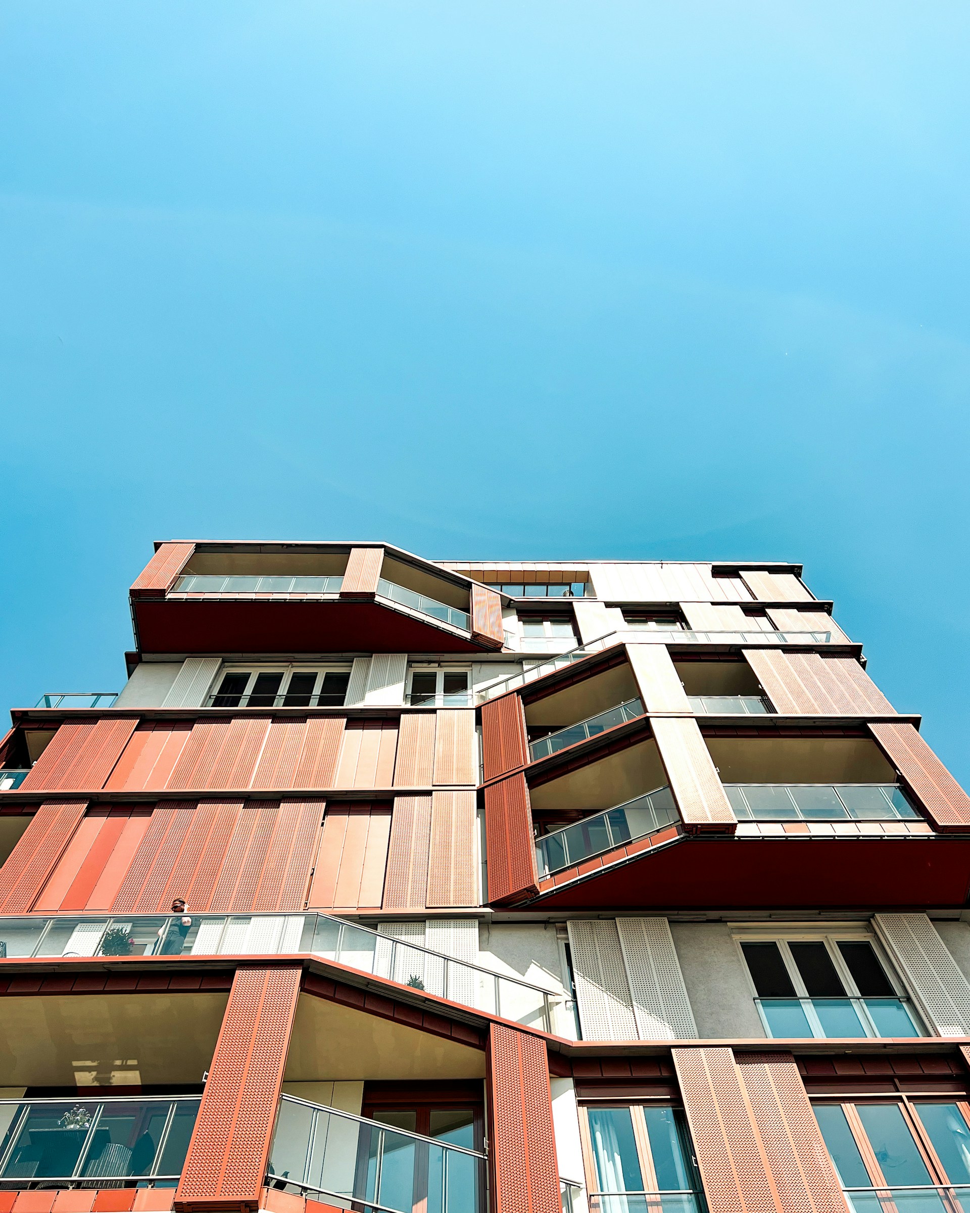 a tall building with lots of windows and balconies