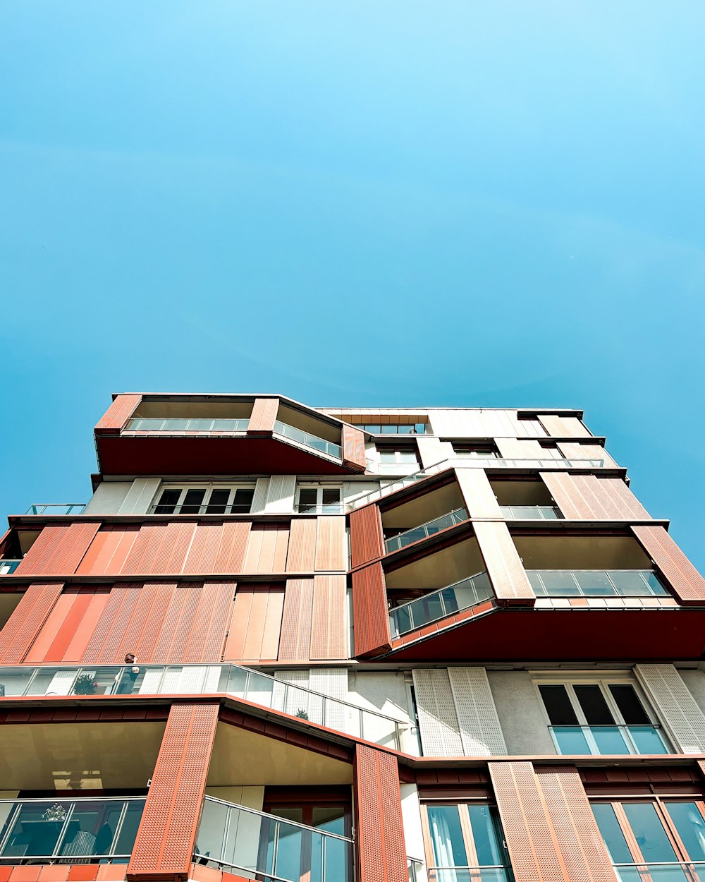 a tall building with lots of windows and balconies