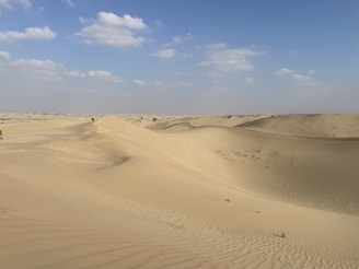 a truck is driving through the sand dunes