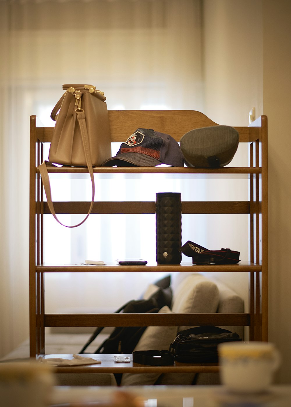 a wooden shelf with a purse and shoes on top of it