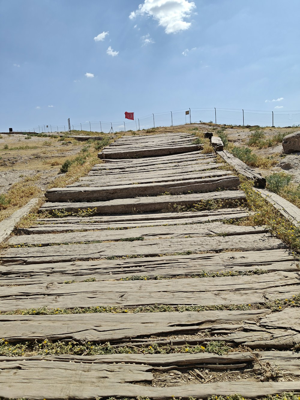 a set of wooden steps leading to a red flag