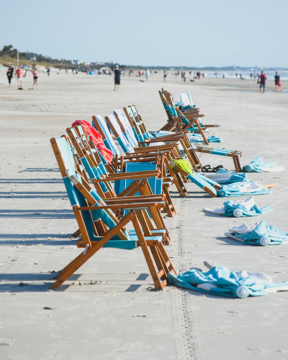 a row of beach chairs sitting on top of a sandy beach