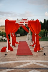 A lively red carpet event with celebrities posing for photographers under bright lights.