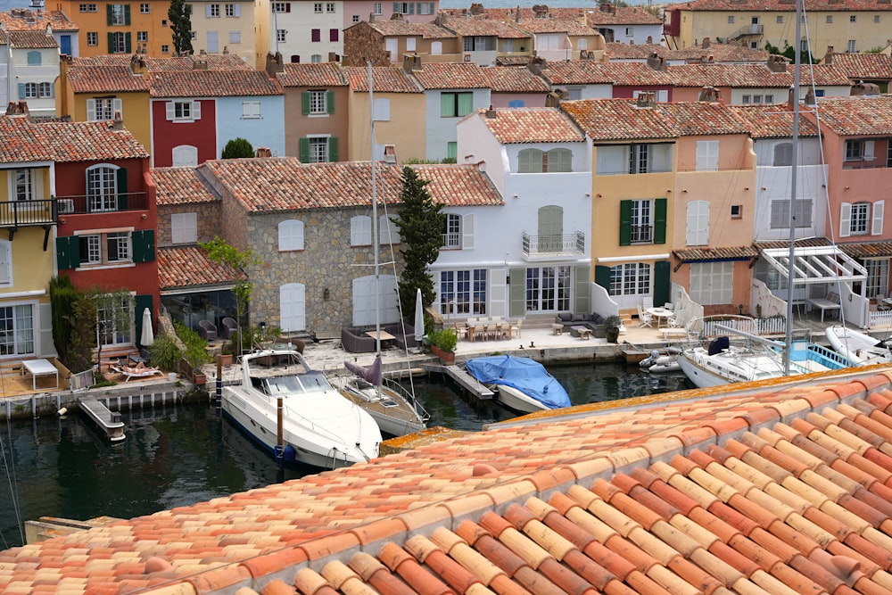 a group of boats parked in a harbor next to buildings