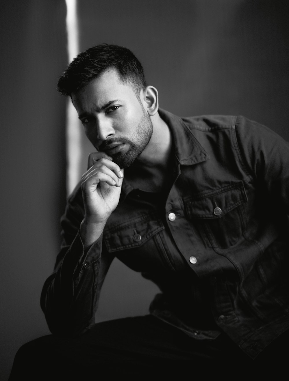 a black and white photo of a man in a shirt