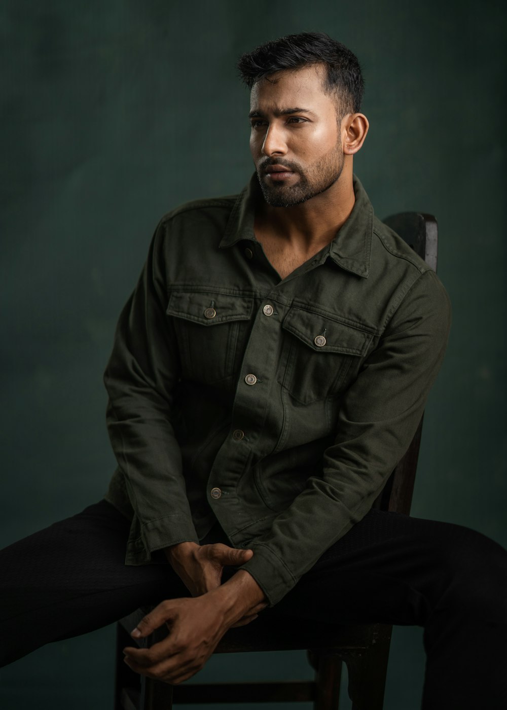 a man sitting in a chair with his legs crossed