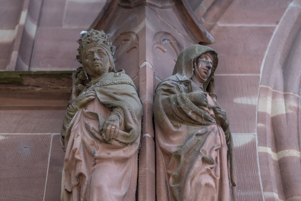 a statue of two women holding a baby