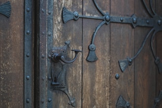 Antique pewter iron door featuring classic craftsmanship details and a secure locking mechanism.