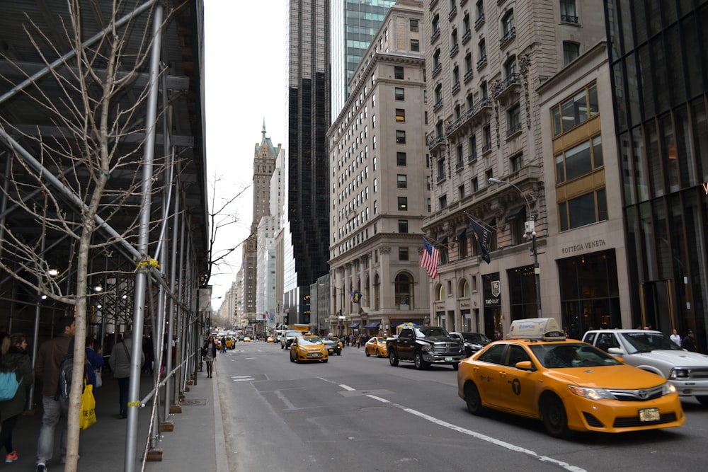 a city street filled with lots of traffic and tall buildings