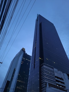 a couple of tall buildings sitting next to each other
