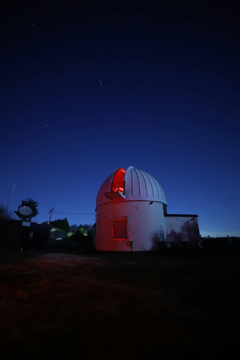 a large white building with a red light on top of it