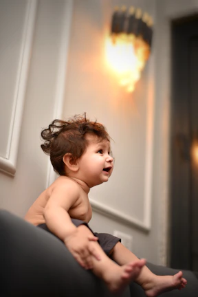 A cheerful child playing happily under the watchful eye of a caring babysitter