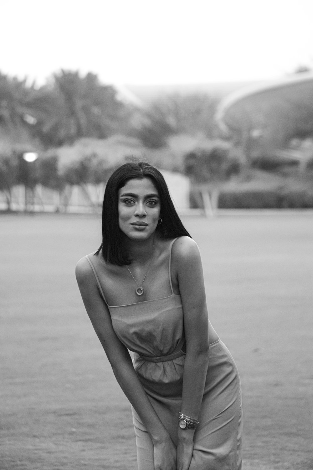 a black and white photo of a woman in a dress