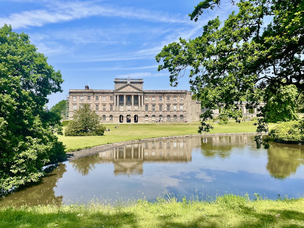 a large building sitting on top of a lush green field