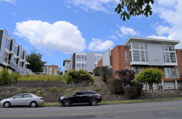 Modern townhouse exterior with large windows and a small garden.