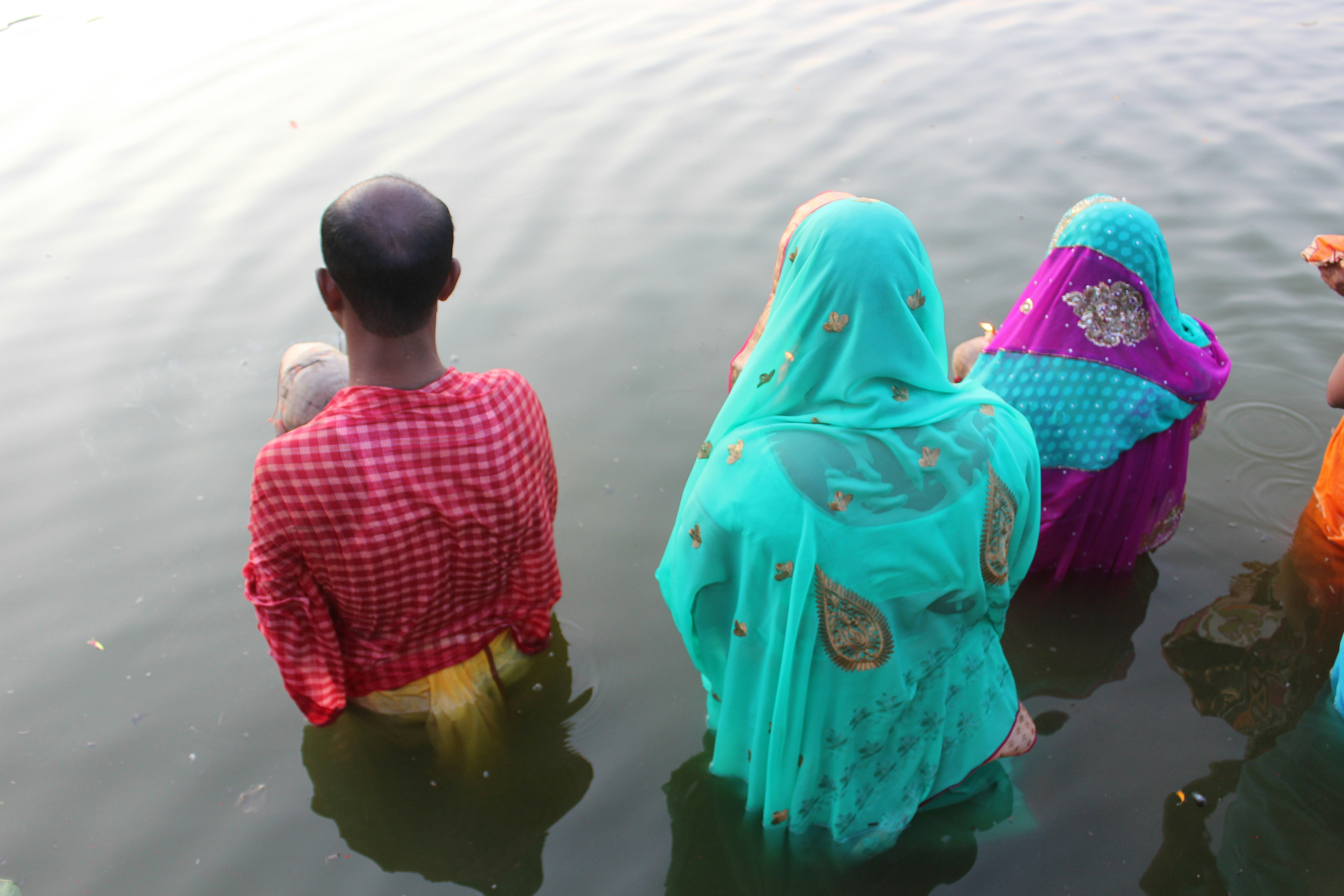 a group of people standing in a body of water