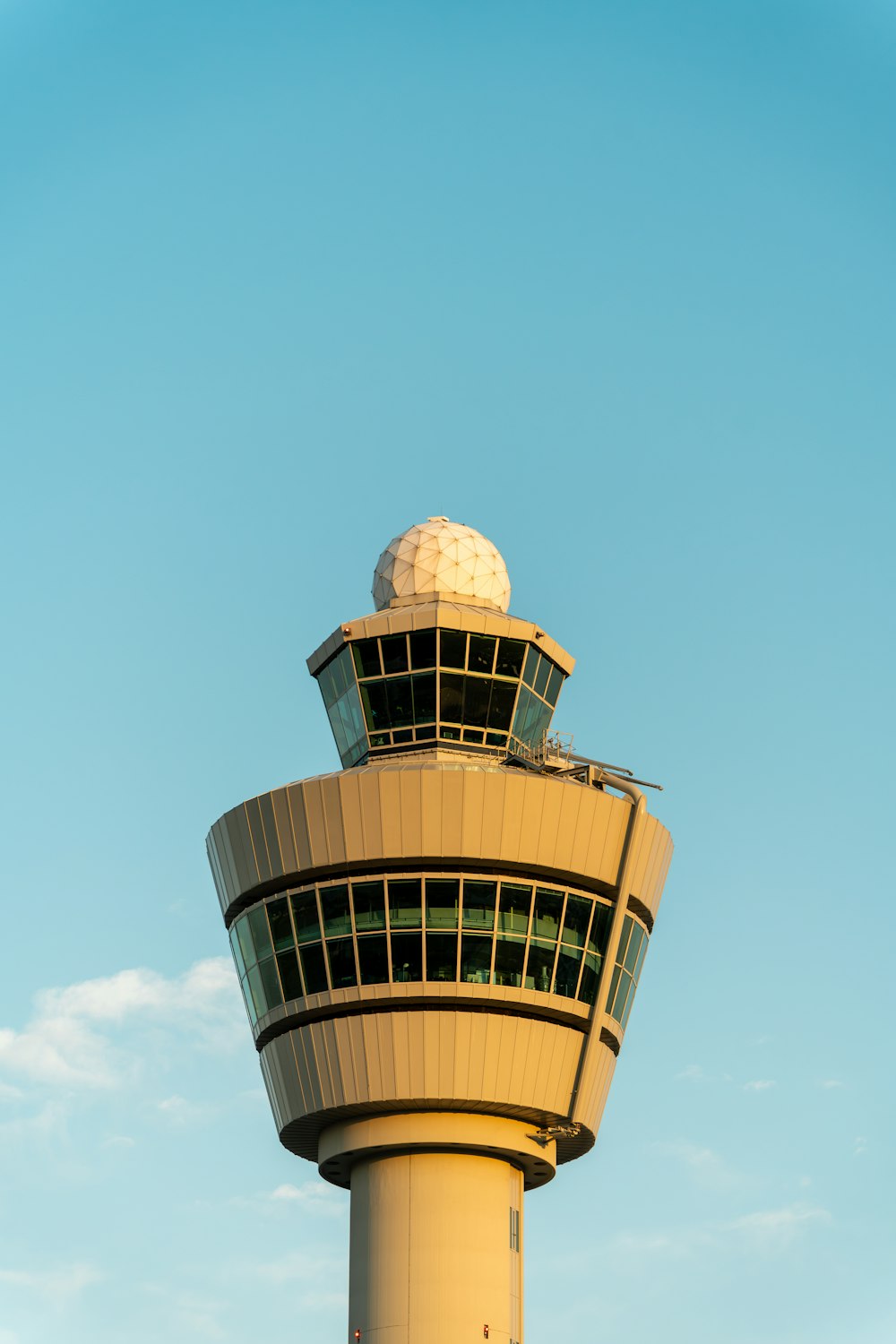 a tall tower with a white top and a sky background