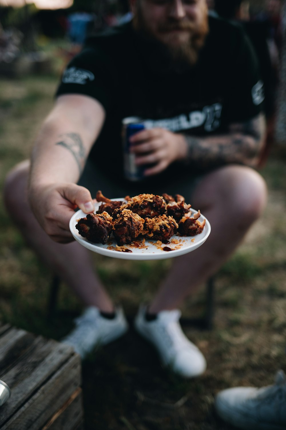 a man holding a plate of food in his hands