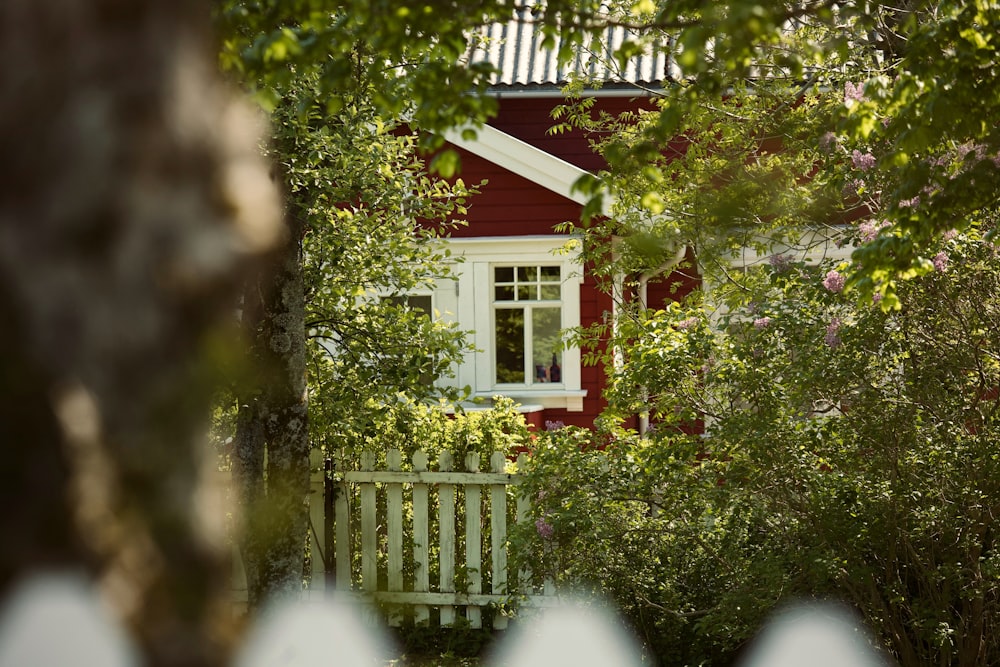 a red house with a white picket fence