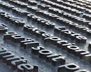 a close up of a metal surface with letters