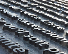 a close up of a metal surface with letters