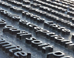 a close up of a metal surface with letters