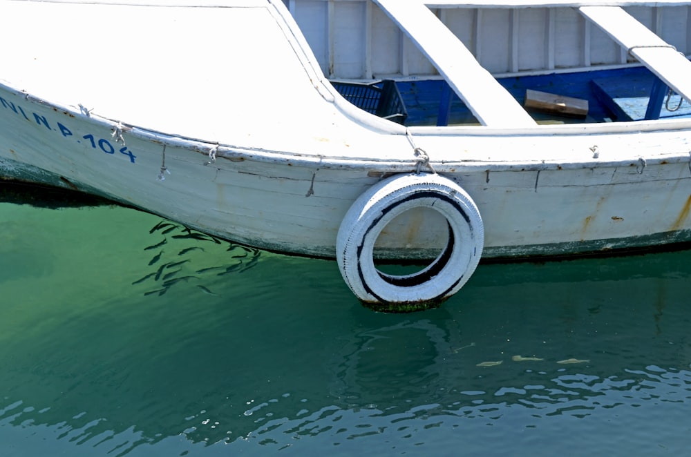 a white boat is sitting in the water