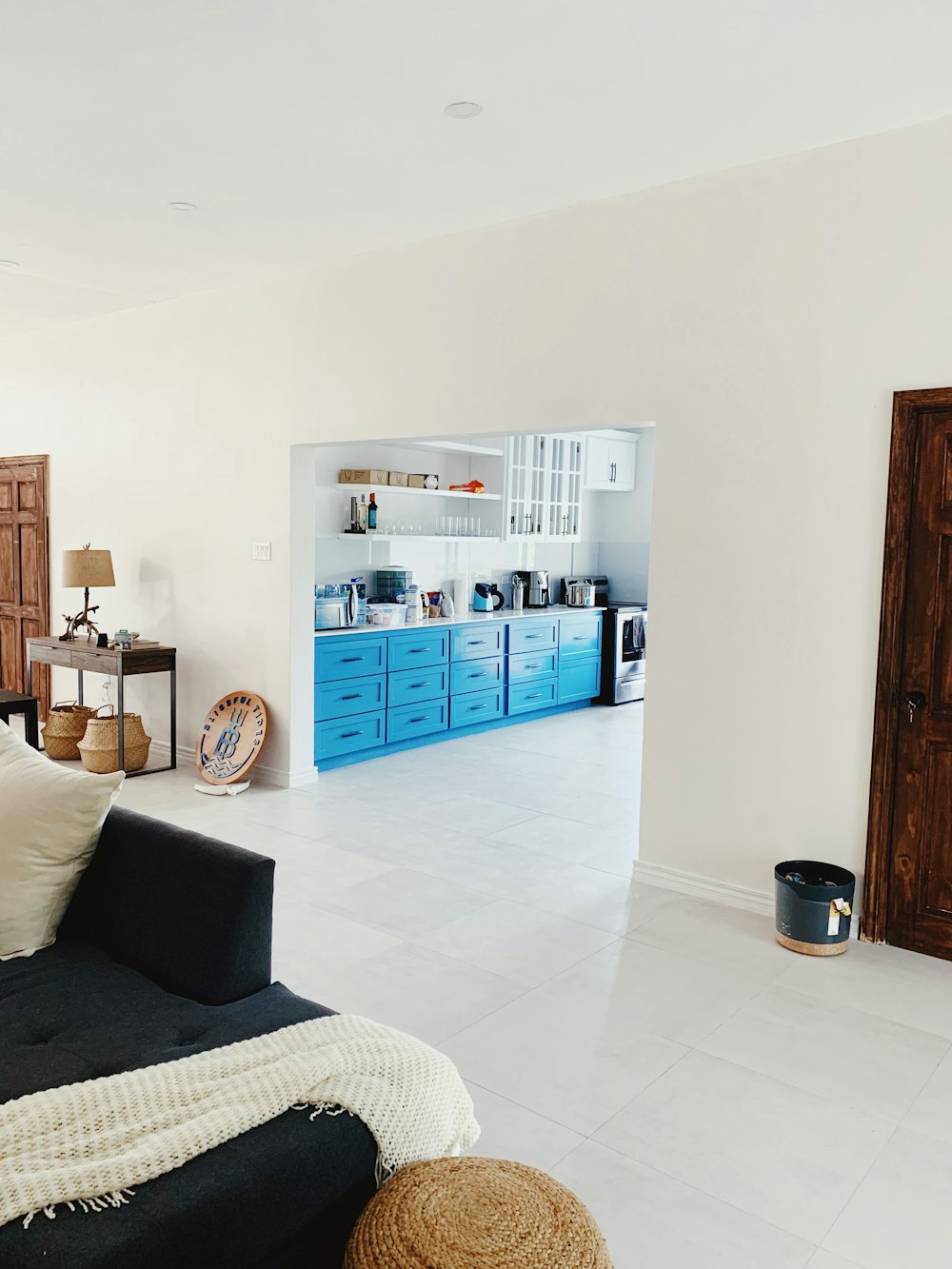 a living room filled with furniture and a blue cabinet