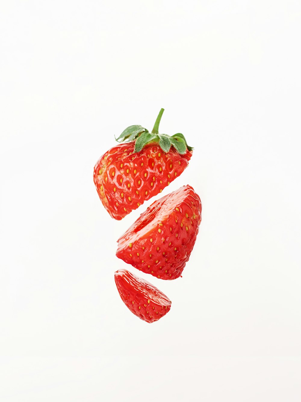 a group of strawberries flying through the air