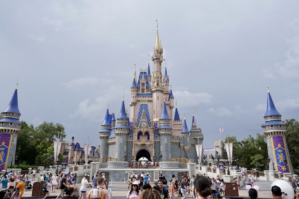 A happy family enjoying a magical day at Walt Disney World with Cinderella's Castle in the background.