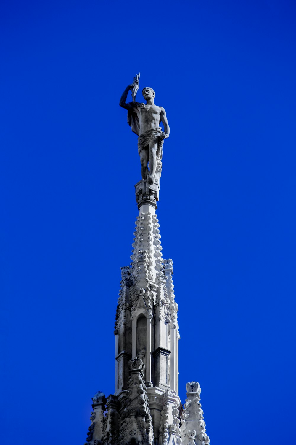 a tall building with a statue on top of it