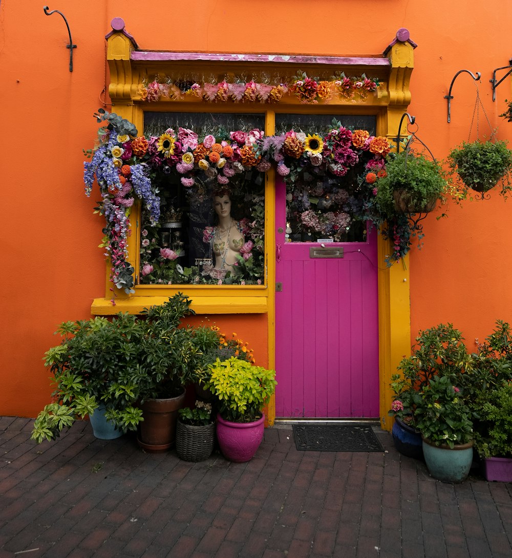 a pink and yellow building with a pink door