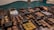 An assortment of chocolates displayed in a glass case. Each type of chocolate has a small sign indicating its flavor or filling, such as pecan, walnut, almond, and peanut. The chocolates are arranged in neat rows and vary in shape, size, and decoration.