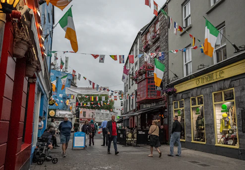 A cozy Dublin street with colorful buildings and lively pedestrians.