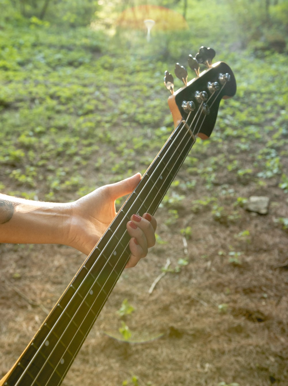 a person holding a bass guitar in their hand