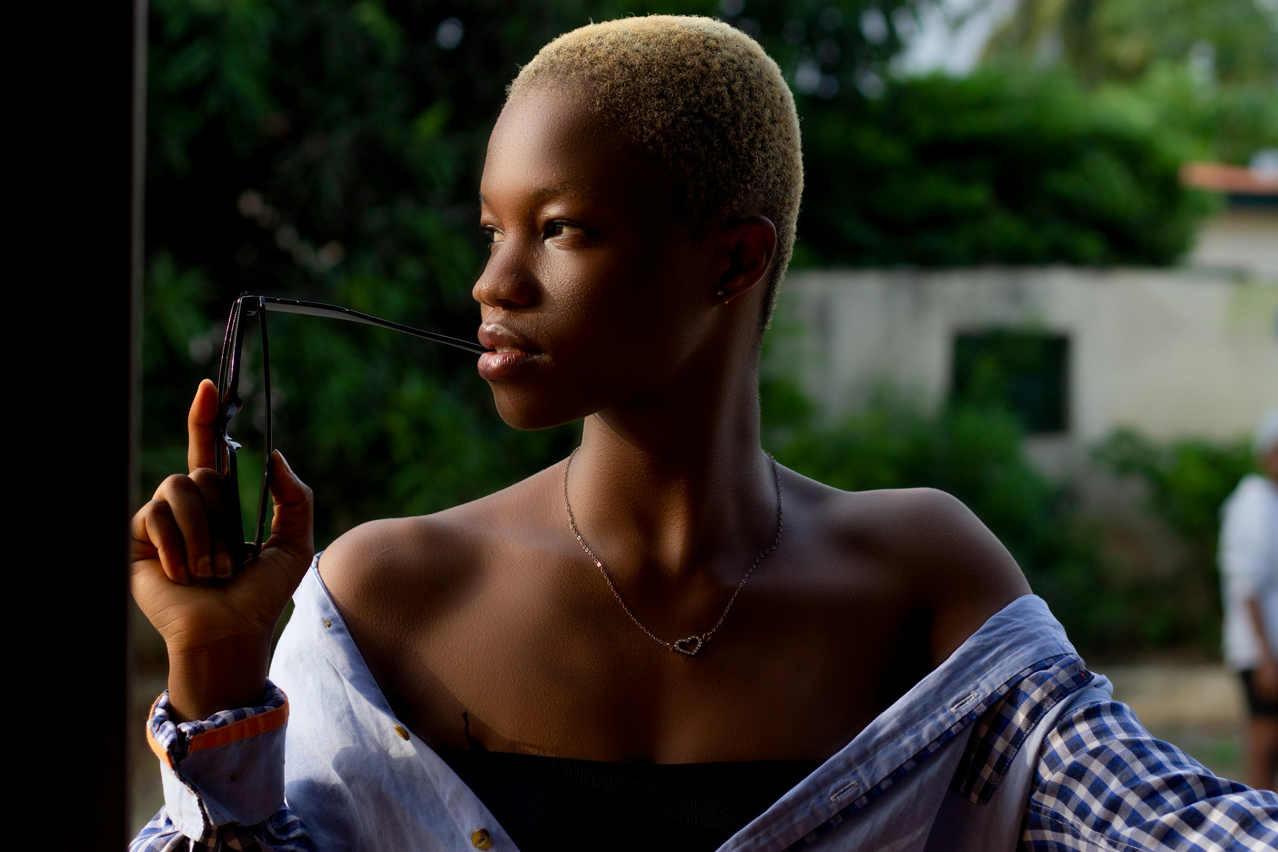 a woman holding a pair of scissors in her right hand