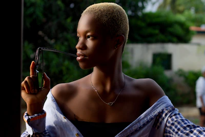 a woman holding a pair of scissors in her right hand