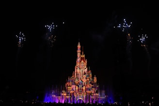 A vibrant screenshot from a recent Kitacraft community event, showing players gathered around a beautifully built castle under a sunset sky.