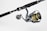 A fishing rod and reel combination featuring a dark handle with metallic accents. The reel has gold and black components with detailed engravings and visible brand markings. It is positioned against a plain, light background.