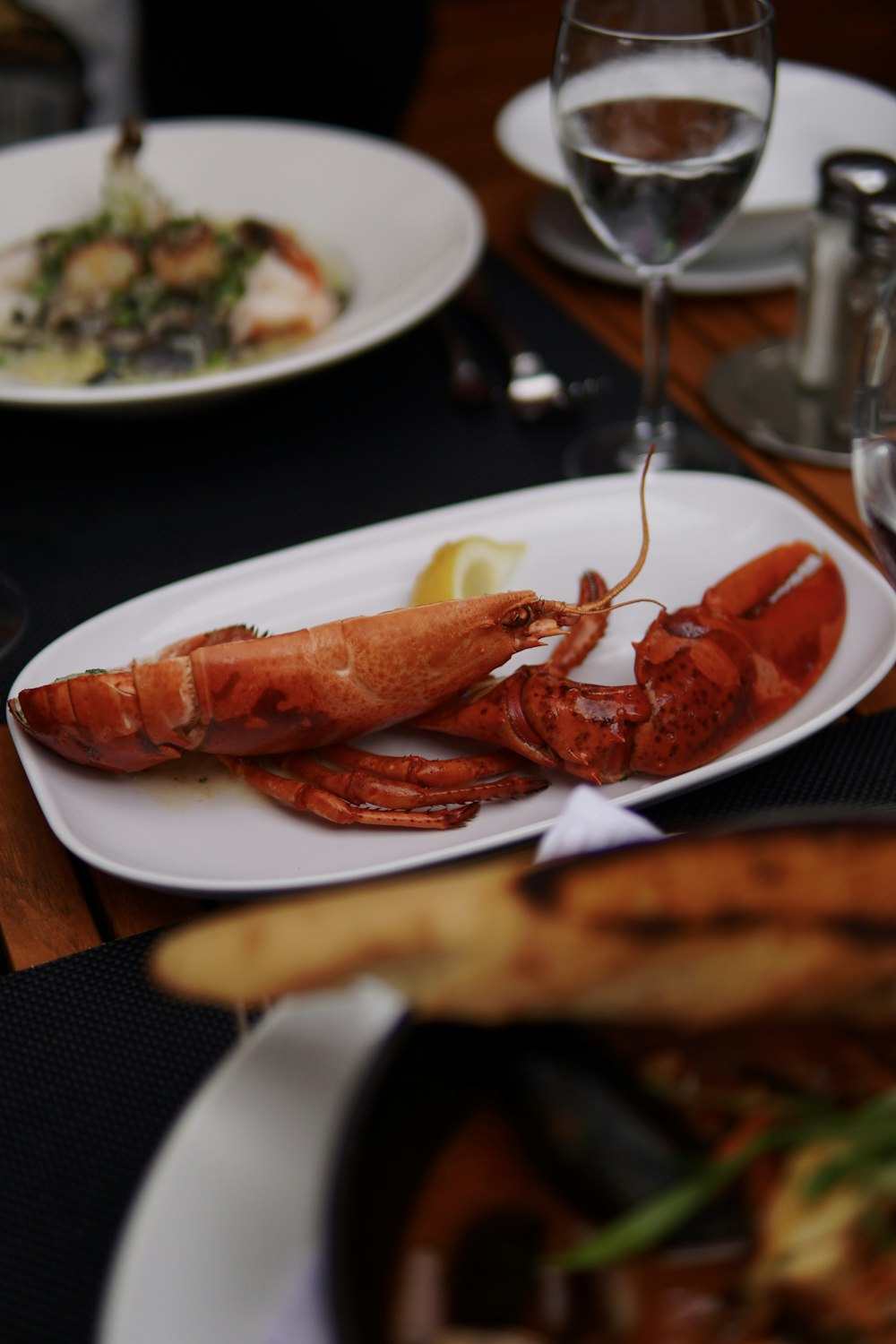 a lobster is on a white plate on a table