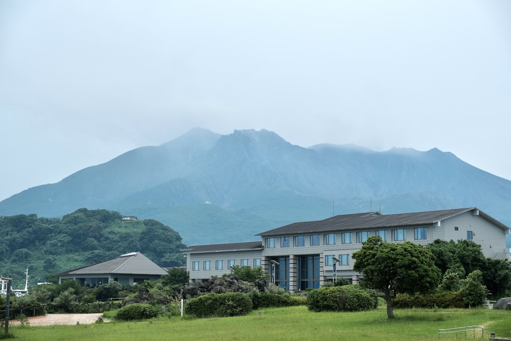 a large house with a mountain in the background