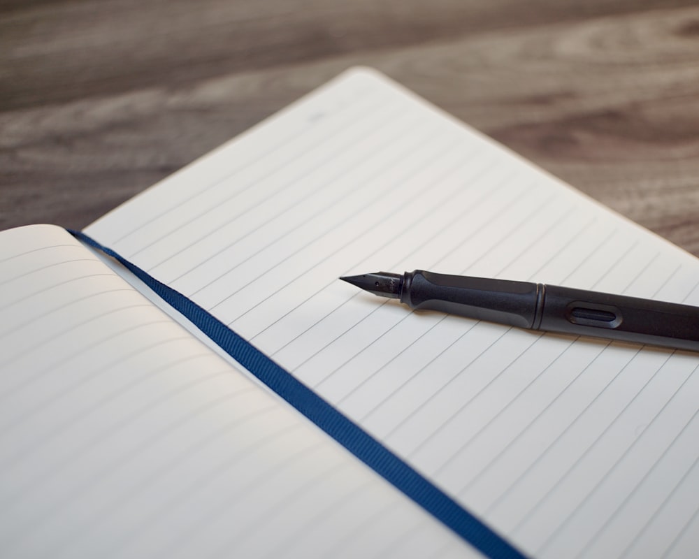 a pen sitting on top of a notebook