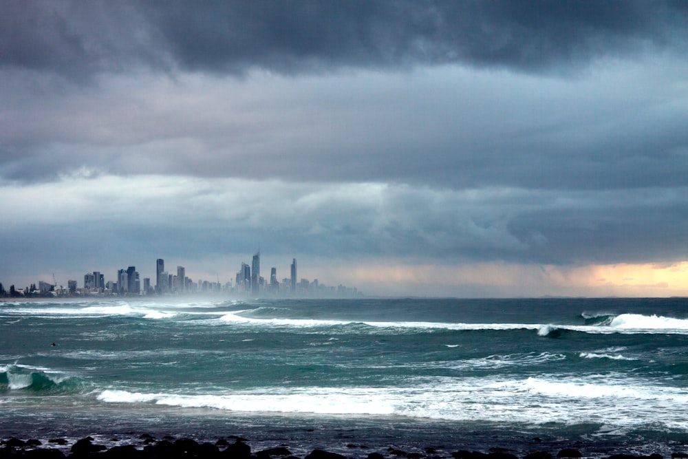 a large body of water with a city in the background