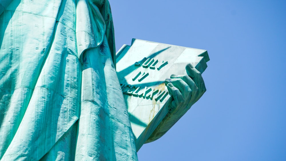 a close up of a statue of liberty holding a book