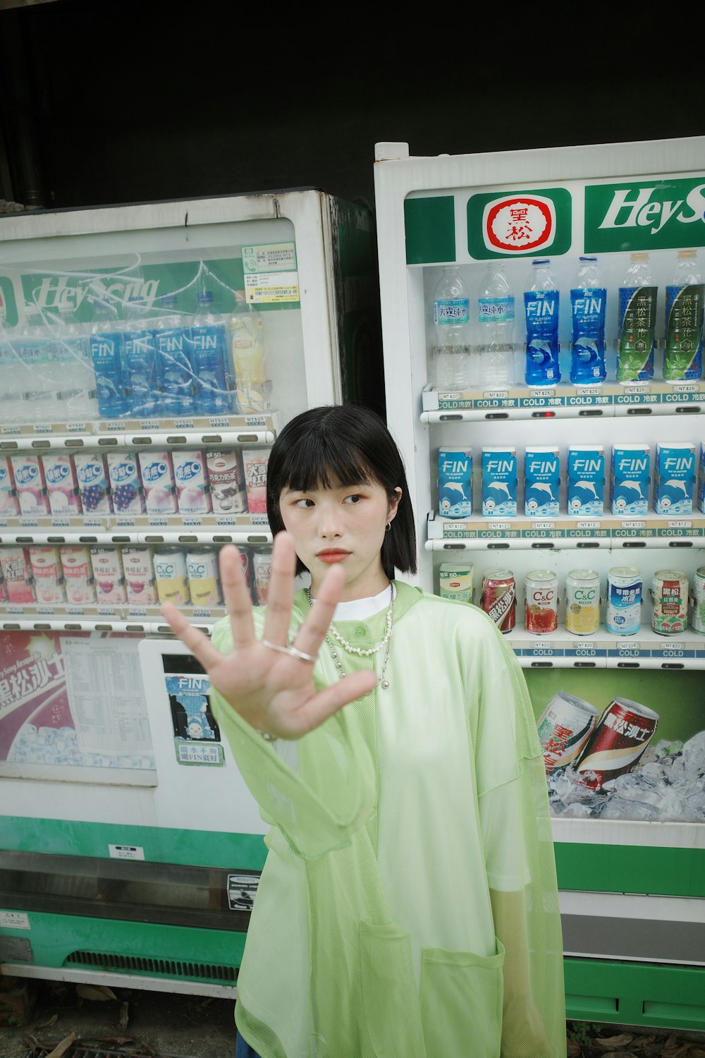 a woman standing in front of a vending machine